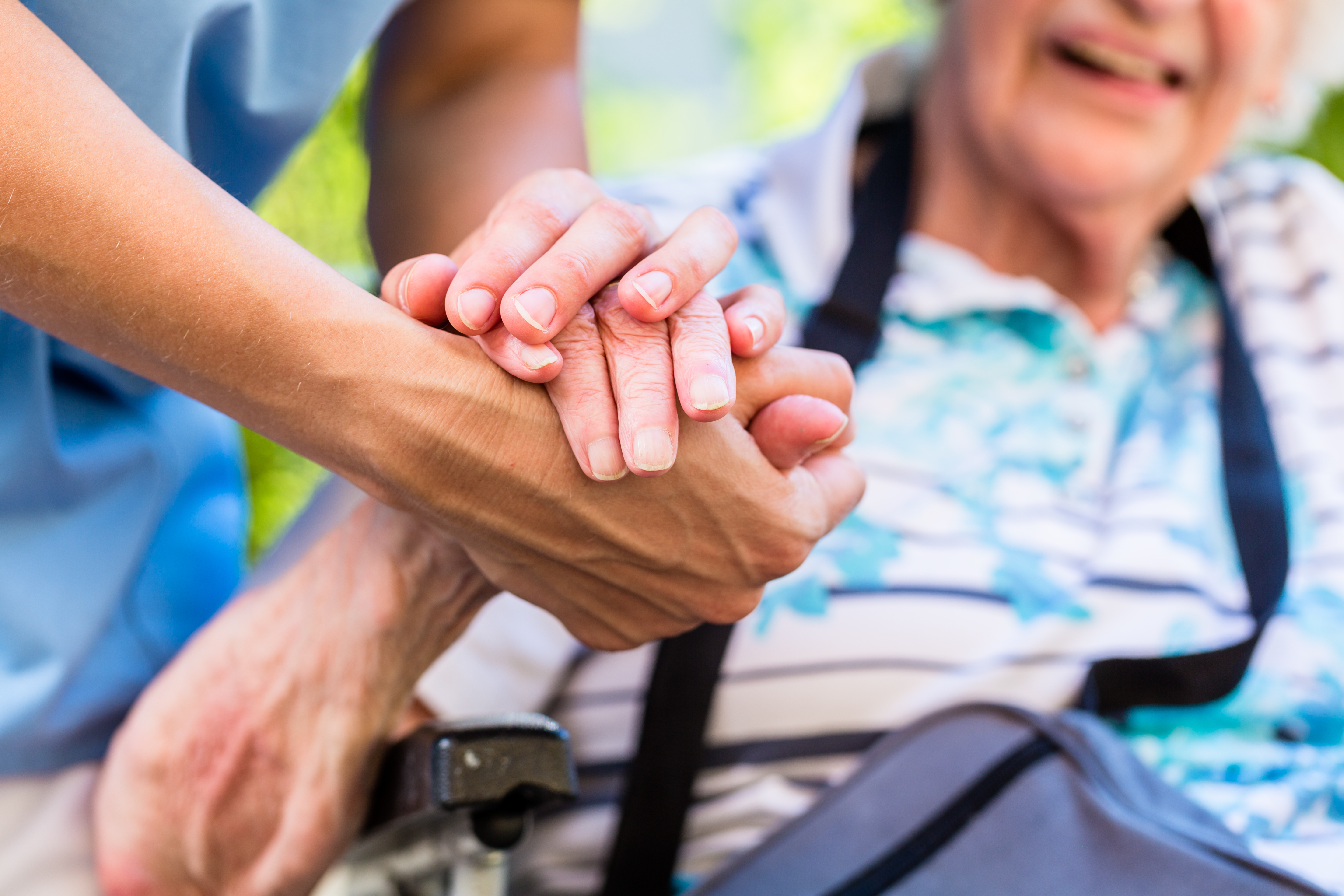 Nurse consoling senior woman holding her hand Nurse consoling senior woman holding her hand