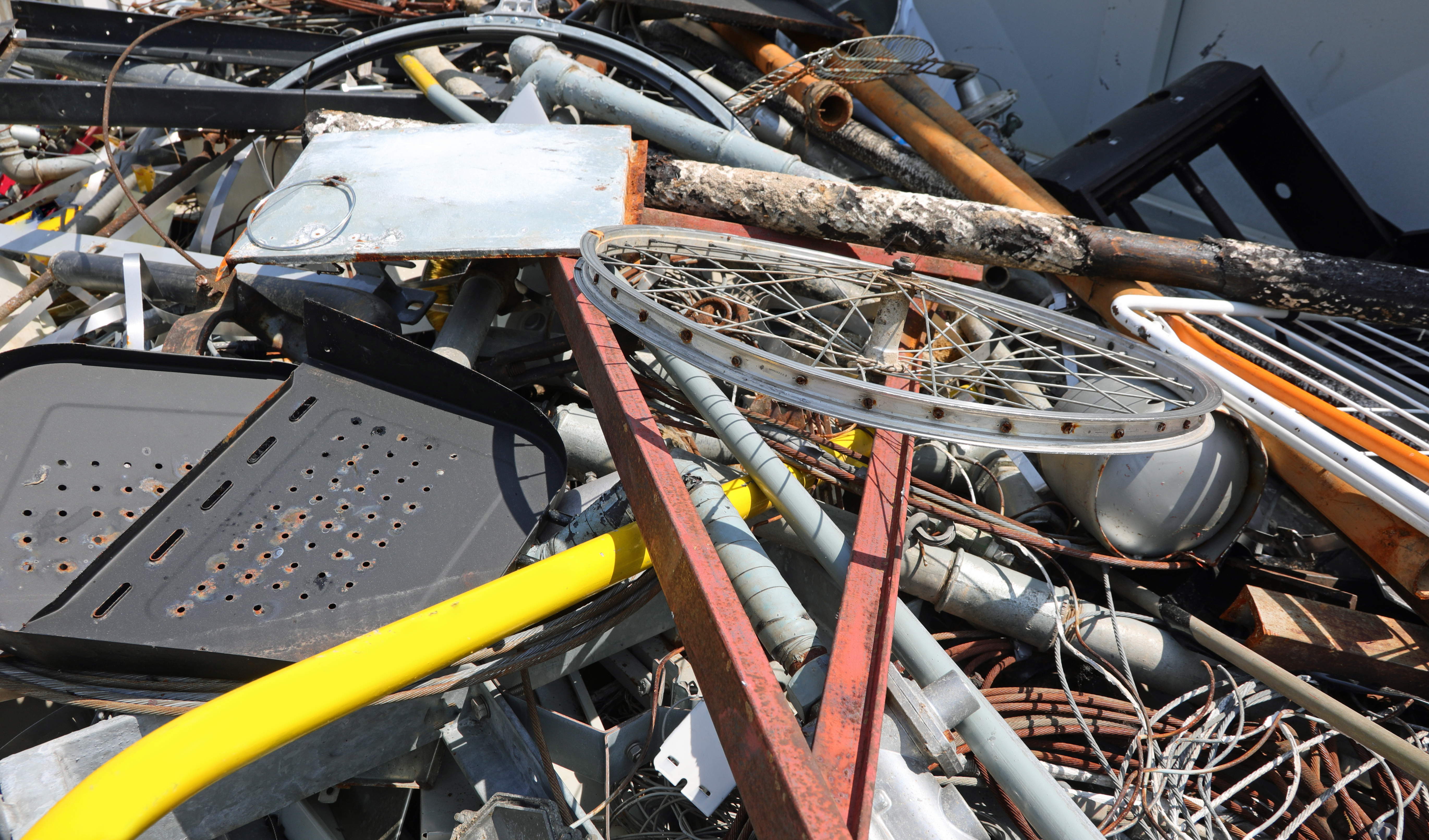 scrap metal and rusty ferrous waste in a landfill for recyclable