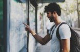 Young bearded traveler man searching the route on a public trans Young bearded traveler man searching the route on a public trans