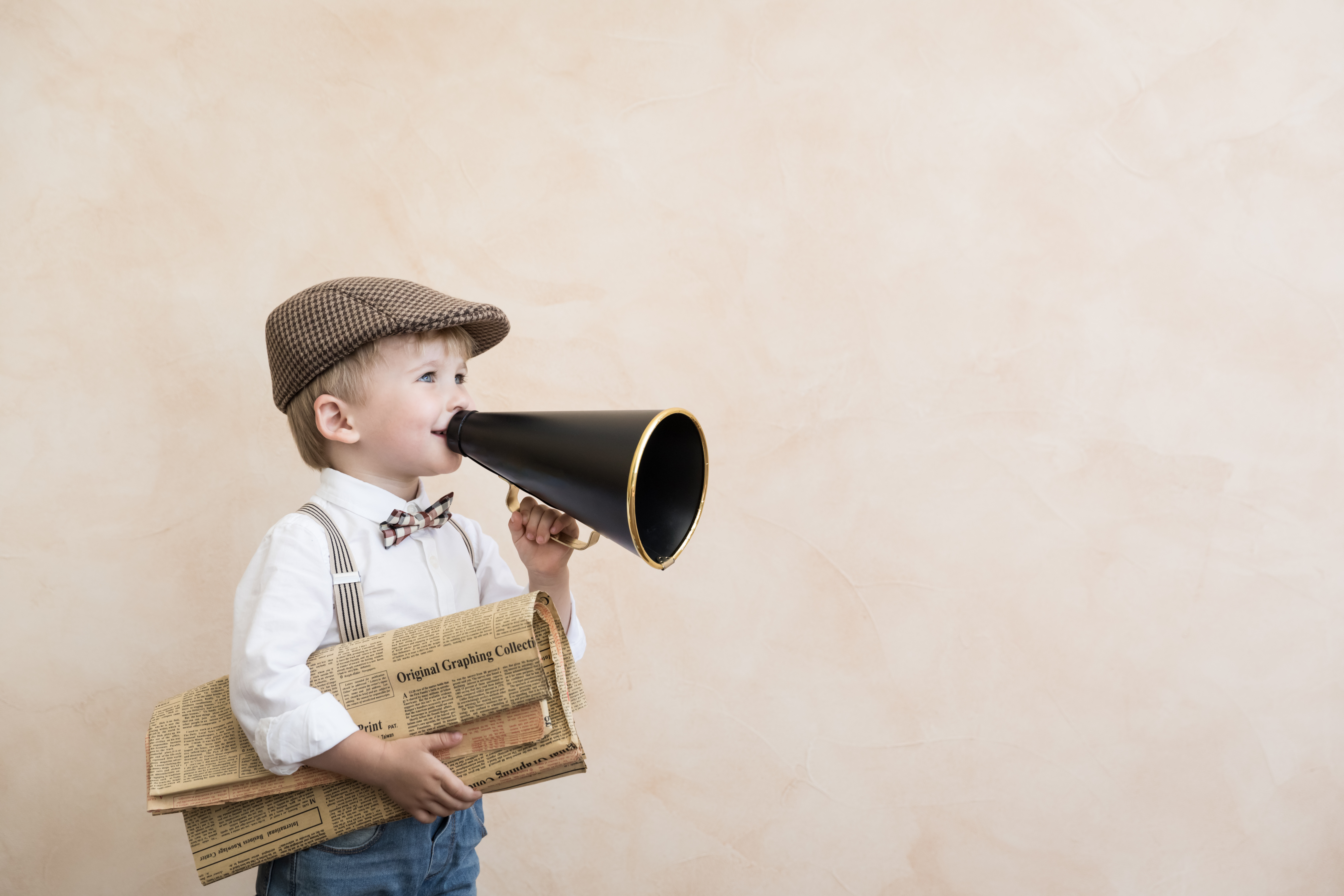 Child shouting through vintage megaphone Child shouting through vintage megaphone