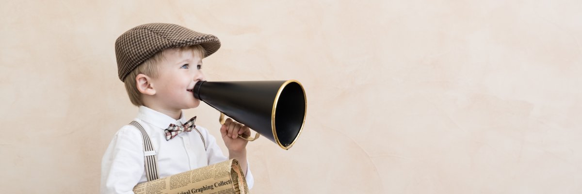 Child shouting through vintage megaphone