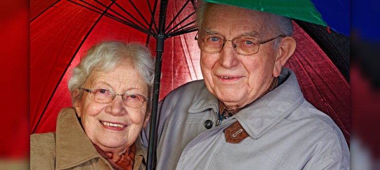 aged couple with umbrella