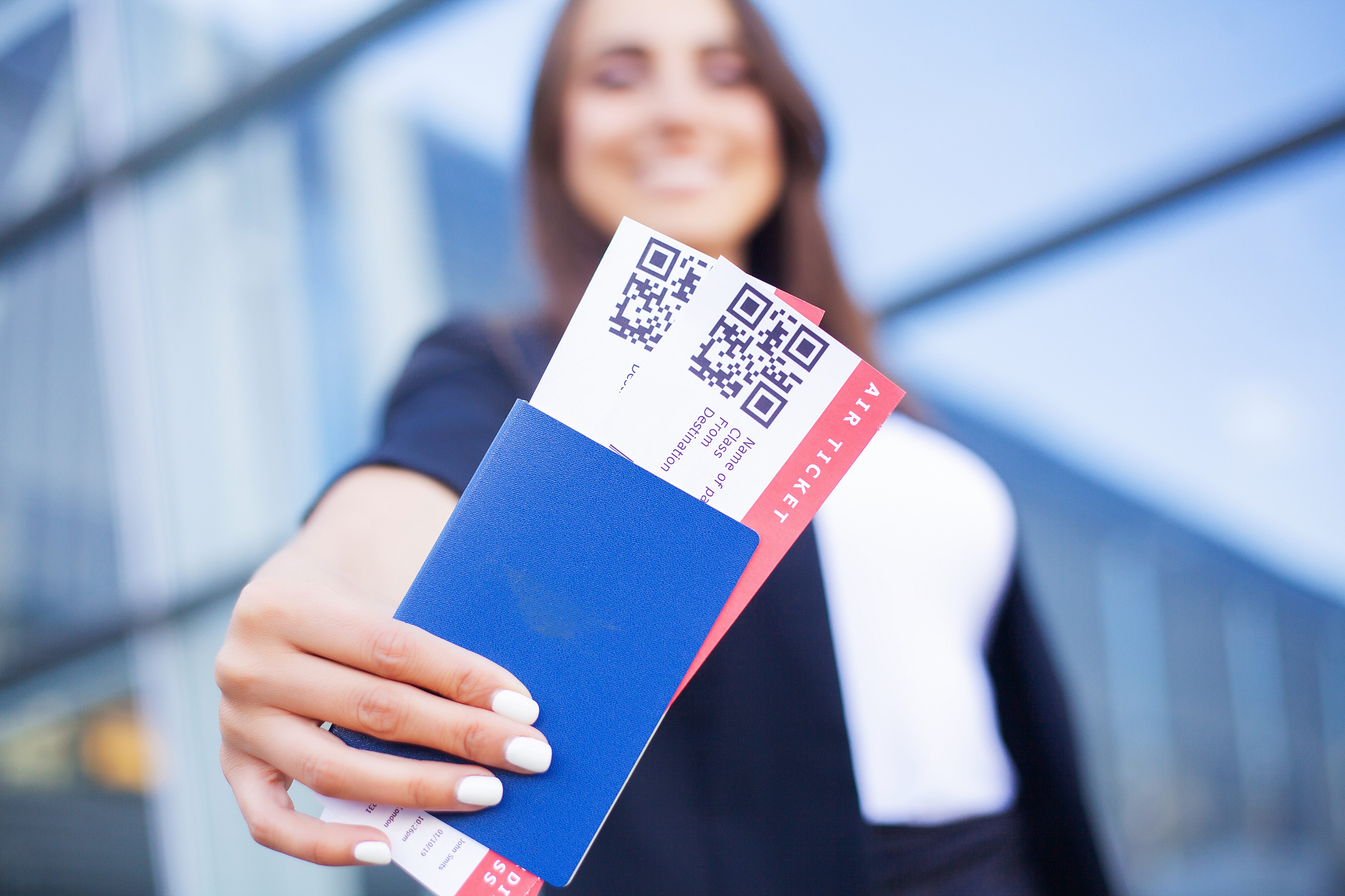 Travel. Woman holding two air ticket in abroad passport near airport Travel. Woman holding two air ticket in abroad passport near airport